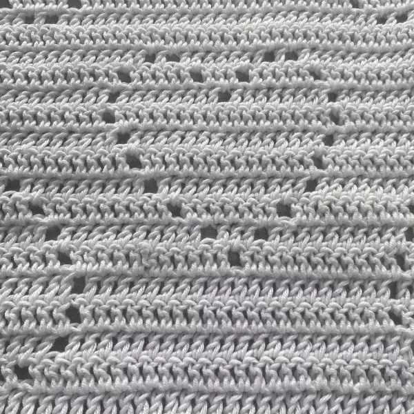 A romantic white crochet baby blanket made of breathable cotton yarn, with delicate heart-shaped patterns and a playful red edge – perfect for Valentine’s Day, springtime strolls, or newborn photo shoots. Soft, heirloom-worthy, and handmade with love.