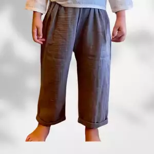 Toddler boys organic double-gauze muslin smokey gray ankle length baggy relax pants, toddler boys fashion, boys chunky harem trousers, available for 2-3-4 years in gray and white, minimalist boys clothes, children's neutral clothing, A child wearing smoky gray baby pants made of organic muslin cotton, designed in a relaxed fisherman style with cuffed legs – perfect for everyday play and summer wear.