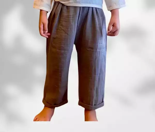 Toddler boys organic double-gauze muslin smokey gray ankle length baggy relax pants, toddler boys fashion, boys chunky harem trousers, available for 2-3-4 years in gray and white, minimalist boys clothes, children's neutral clothing, A child wearing smoky gray baby pants made of organic muslin cotton, designed in a relaxed fisherman style with cuffed legs – perfect for everyday play and summer wear.